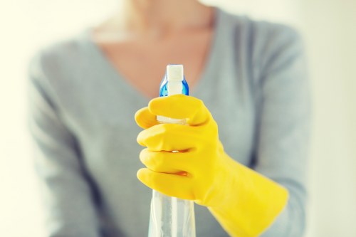Carpet cleaning technician preparing equipment with safety measures in place