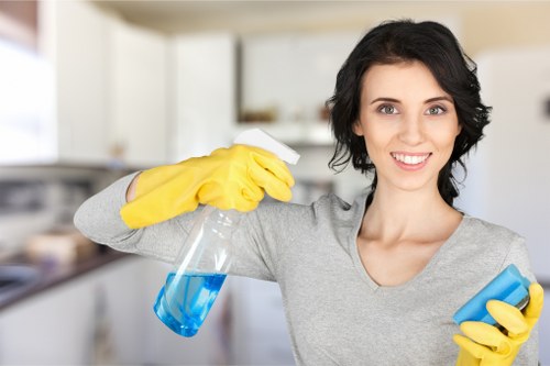 Trained cleaner using protective gloves and safe cleaning practices