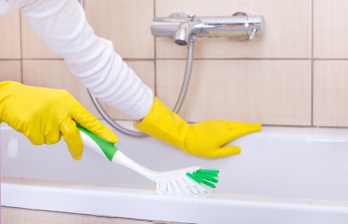Professional carpet cleaner working with protective equipment and careful setup